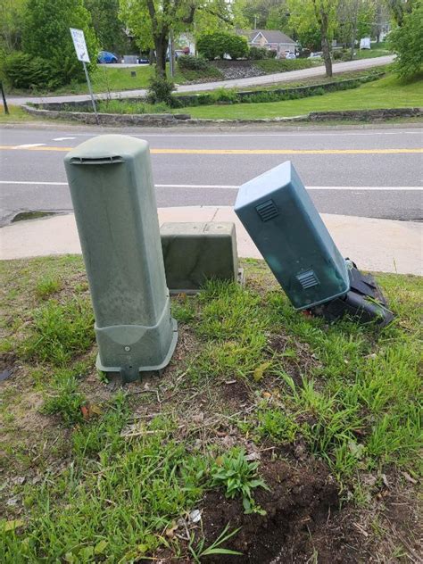 broken electrical boxes gray outside driveway|cable utility box broken.